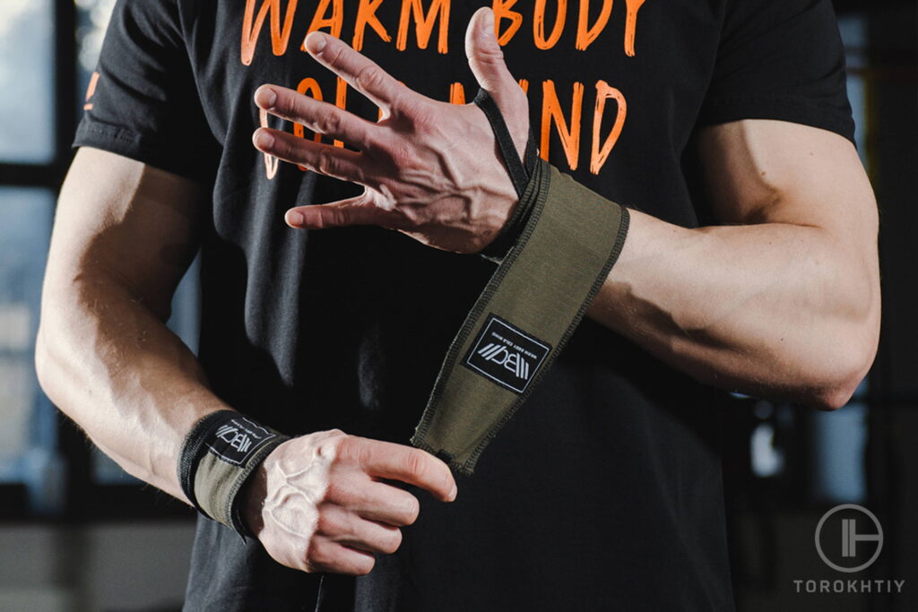 athlete puts on wrist wraps