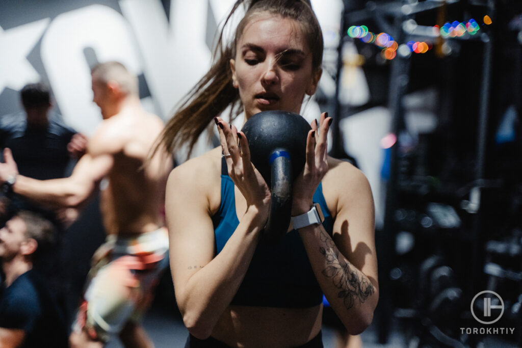 female performing goblet squat with kettlebell