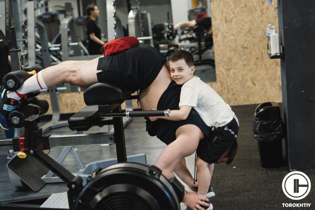 dad and son in gym