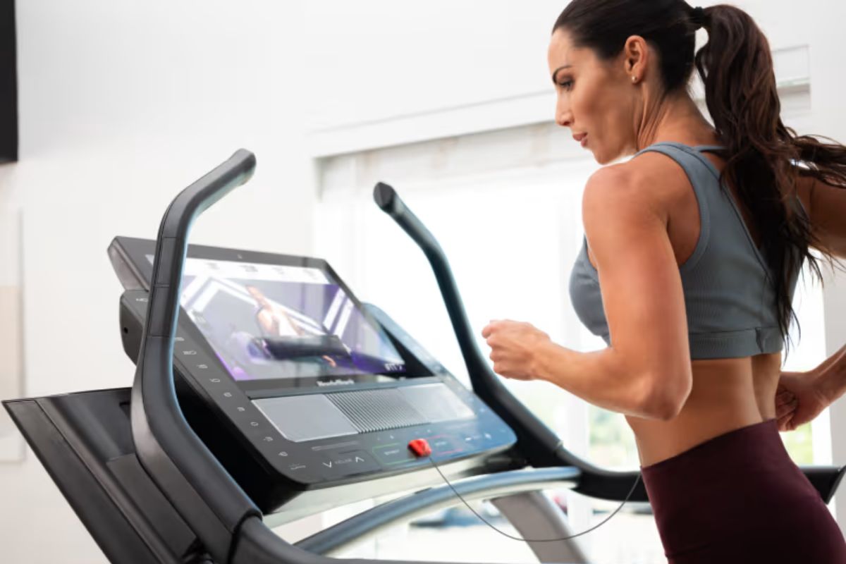 Woman working out on a NordicTrack Commercial X22i treadmill