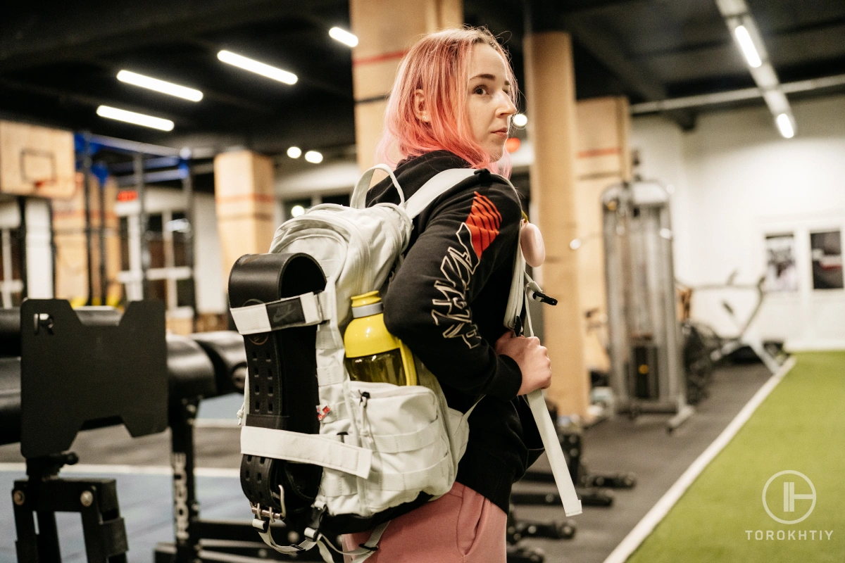 Woman with a backpack on their back in gym