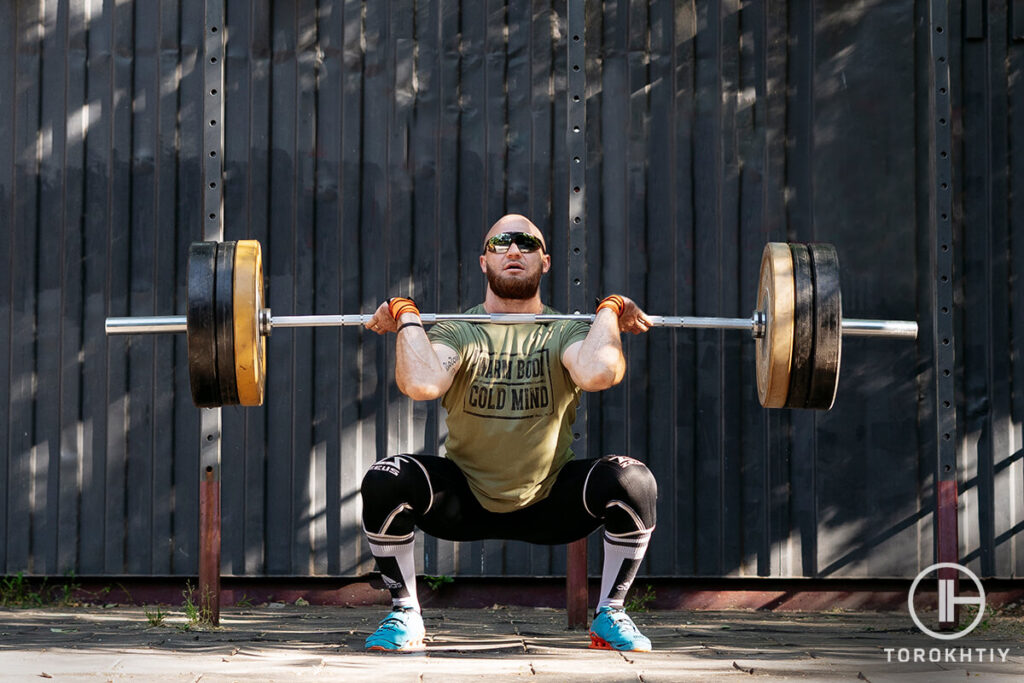 Athlete Front Squatting in Sport Shoes