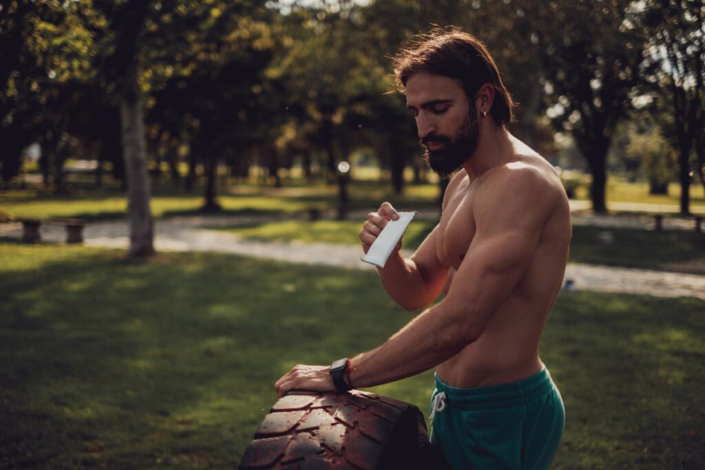 Athlete eating protein bar during training