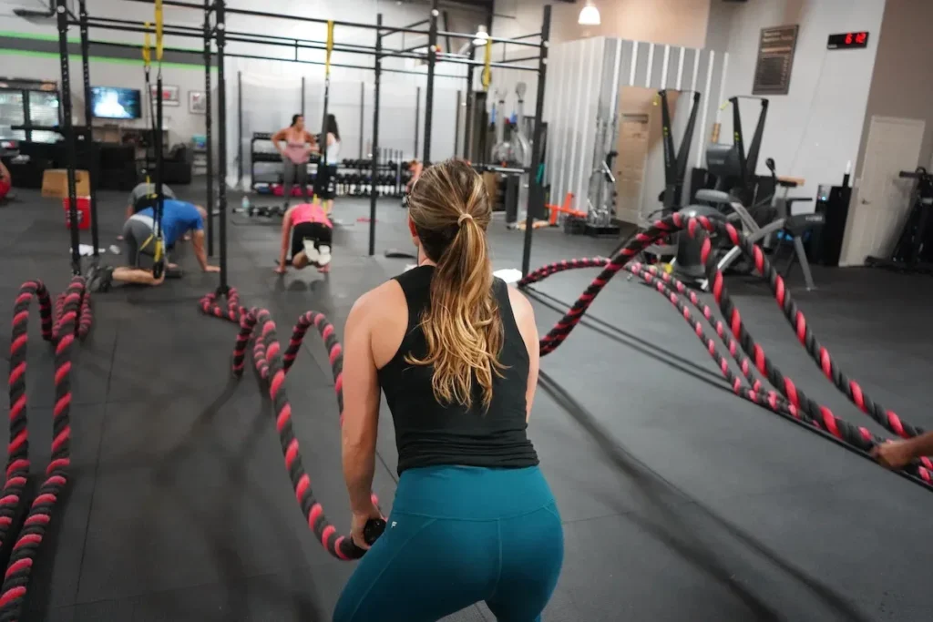 Woman Battle Rope Workout in Gym