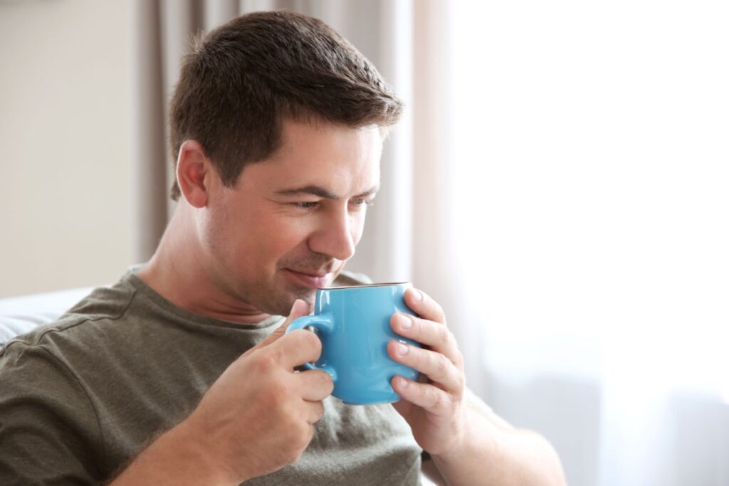 Man drinks coffee at home