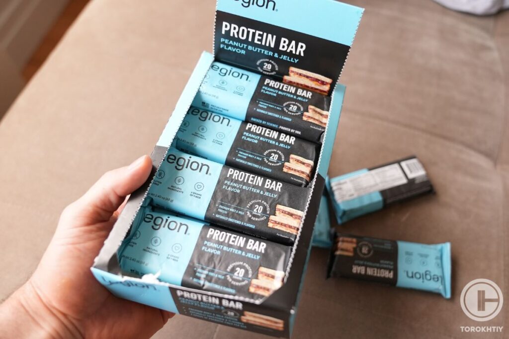 legion protein bars in hands
