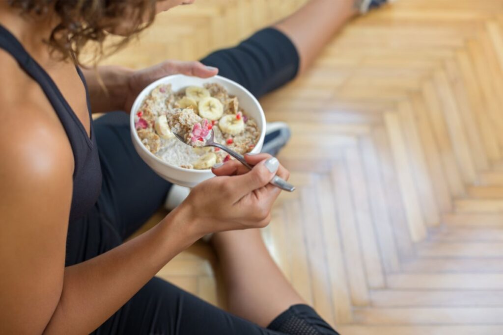 woman eating oatmeal after workout