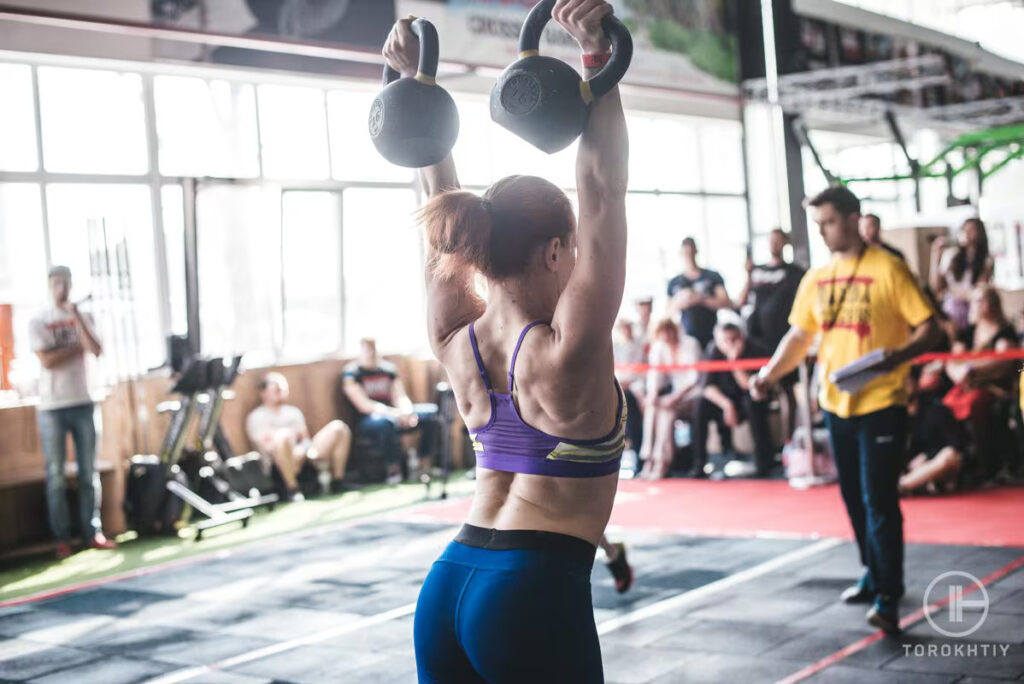 woman trains with kettlebells