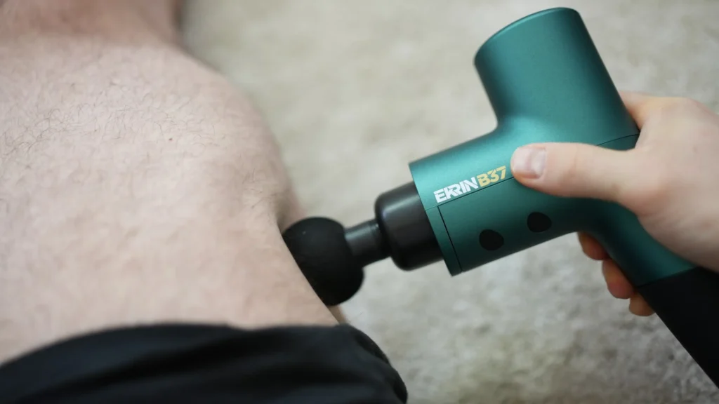 massage gun in use on leg