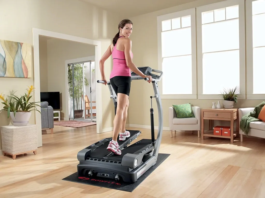 woman trains at home with treadclimber