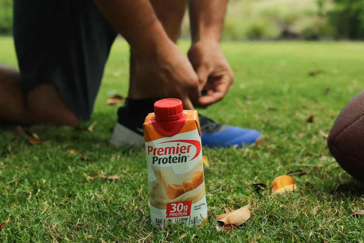 Athlete and the bottle of premiere protein