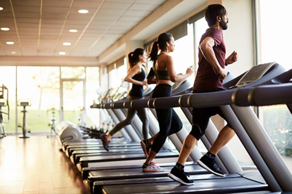 athletes training on treadmills in gym