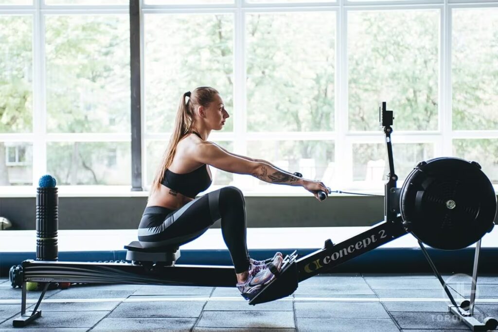 female workout on rowing machine