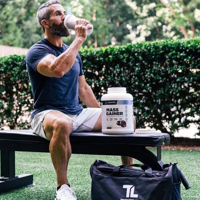 Man drinking Transparent Labs protein
