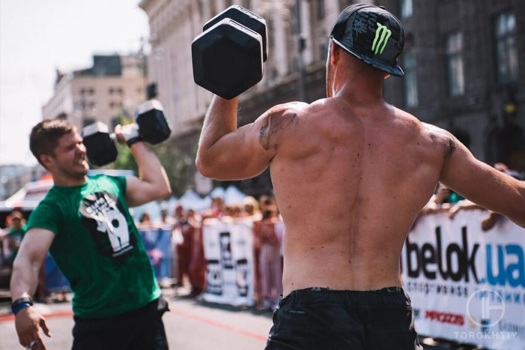athletes with dumbbells on street