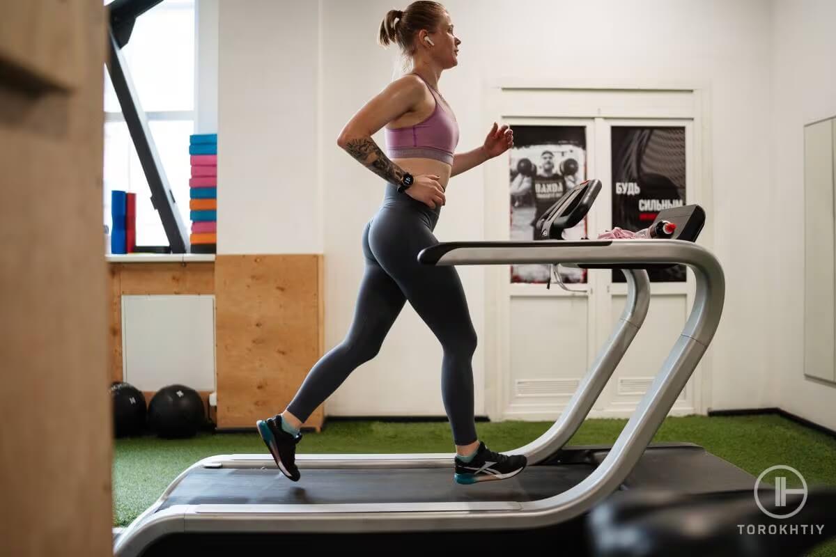 Woman runs on treadmill