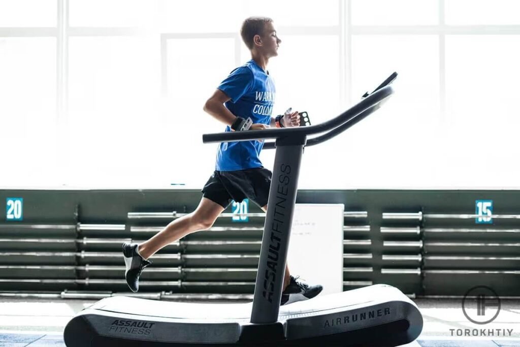 athlete in blue running right on treadmill