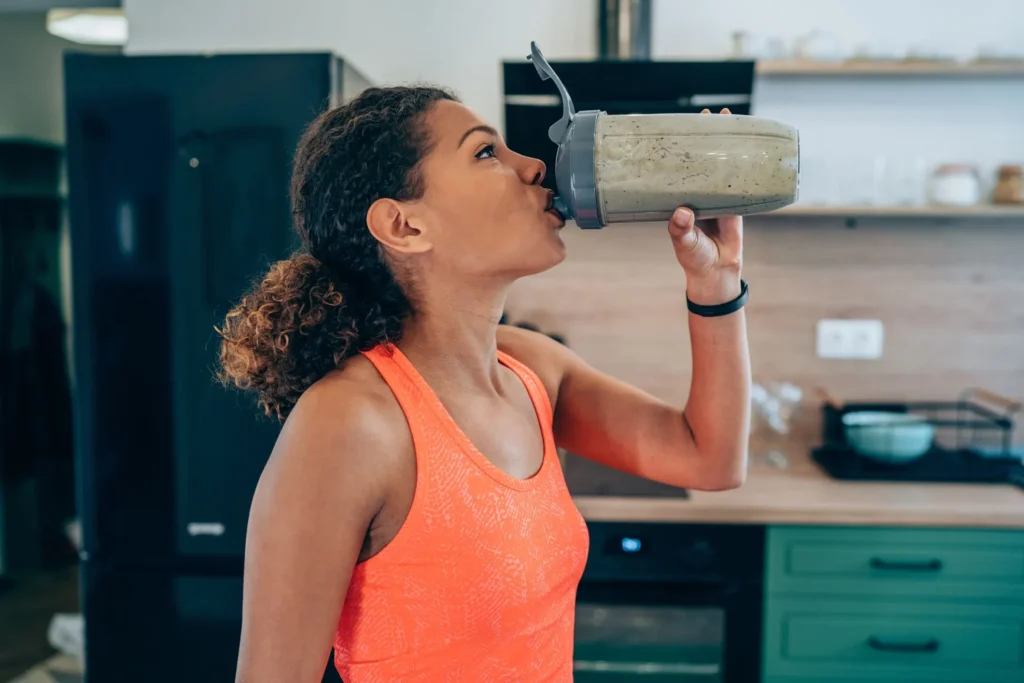 woman drinks a protein shake