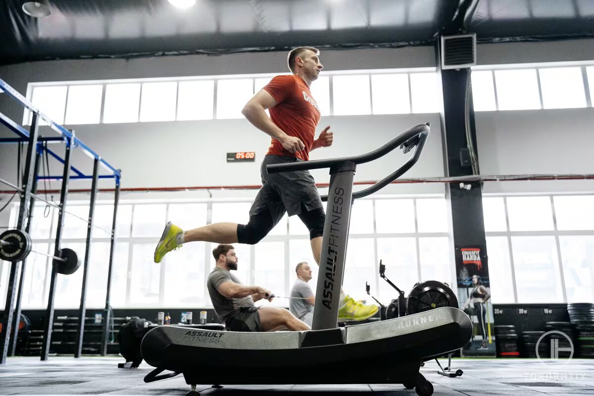 athlete man jogs on treadmill at gym