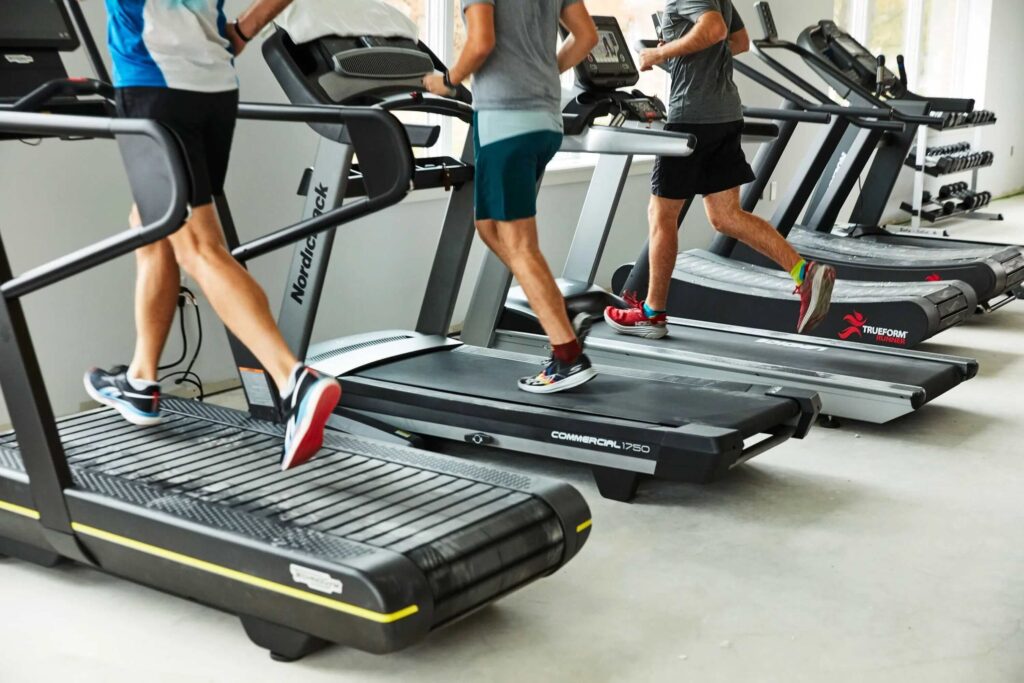 men exercising on treadmills in gym