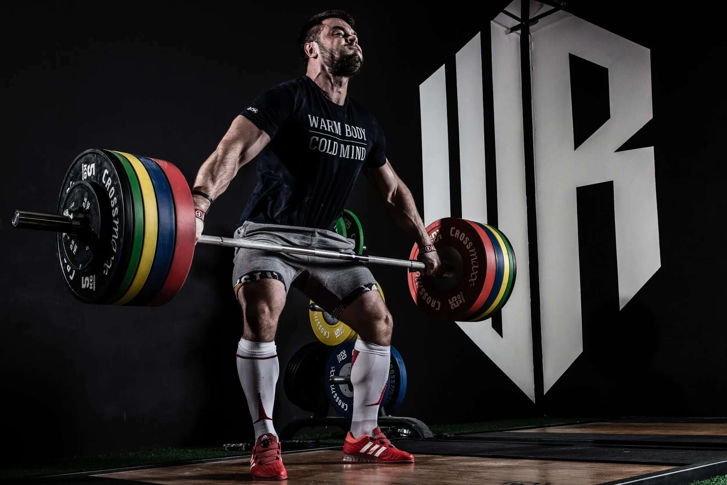 athlete lifts barbell