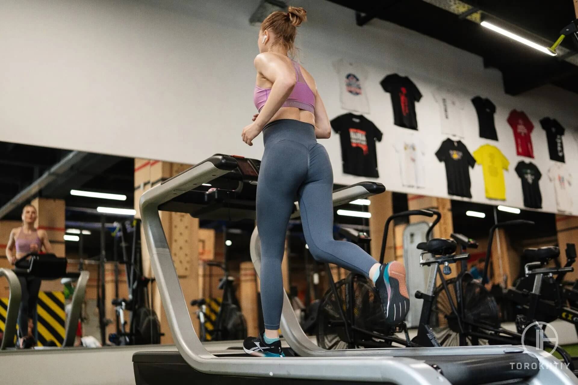 athlete woman runs on treadmill