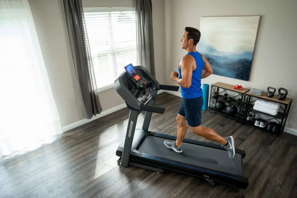 man jogs on treadmill in his home 