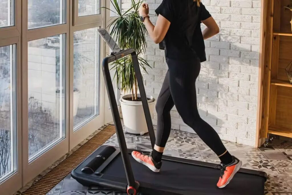 woman exercises on treadmill at home
