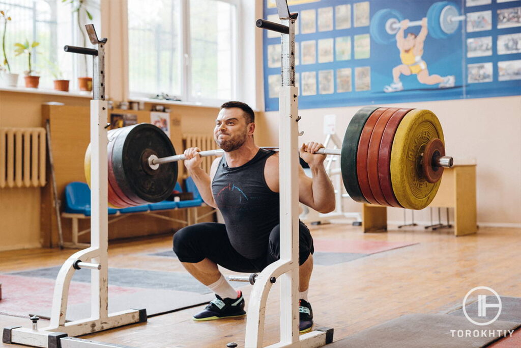 athlete making weightlifting squats