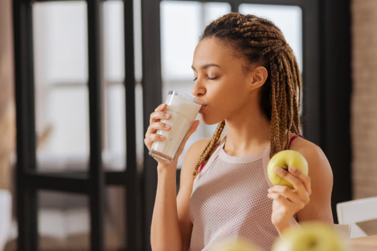 woman drinks protein milk shake