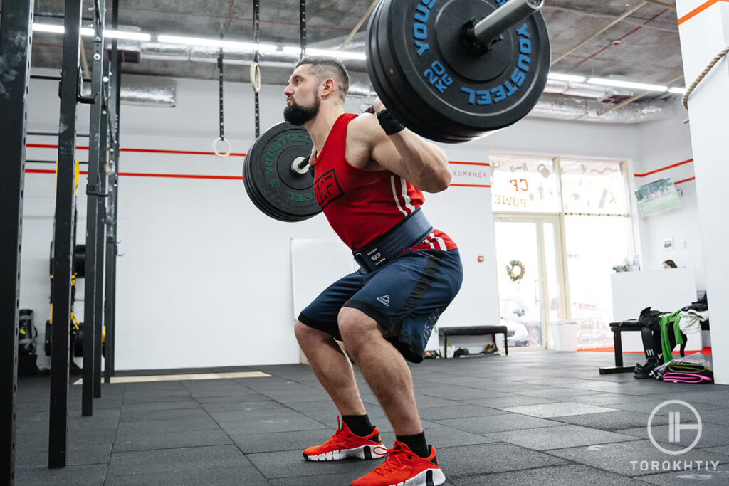 athlete squatting with barbell
