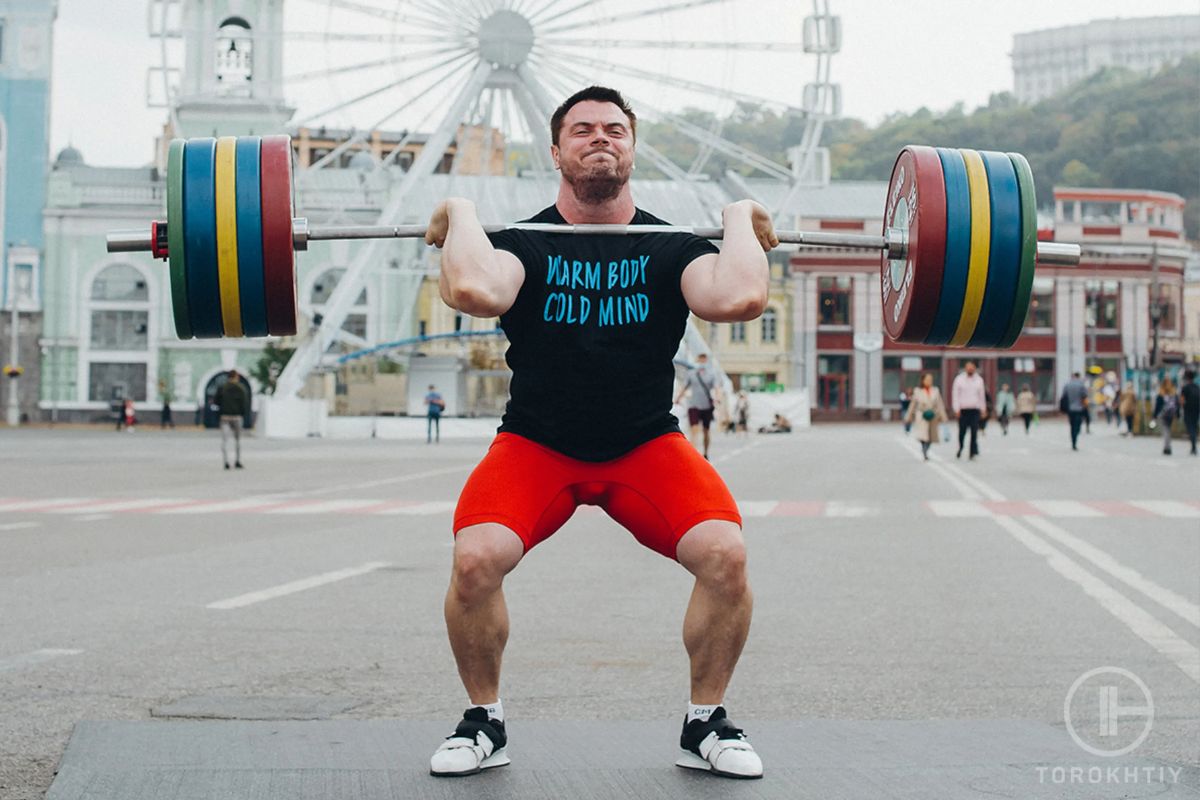 athlete lifts heavy barbell