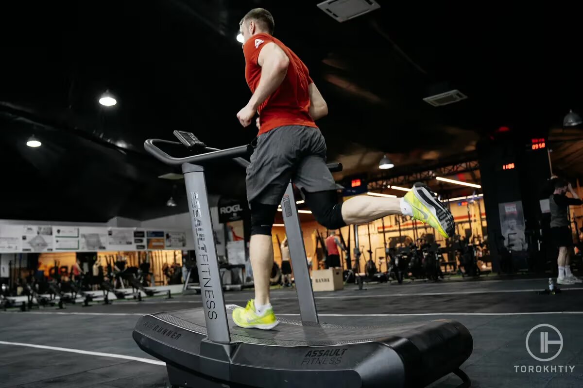 athlete jogs on treadmill in gym