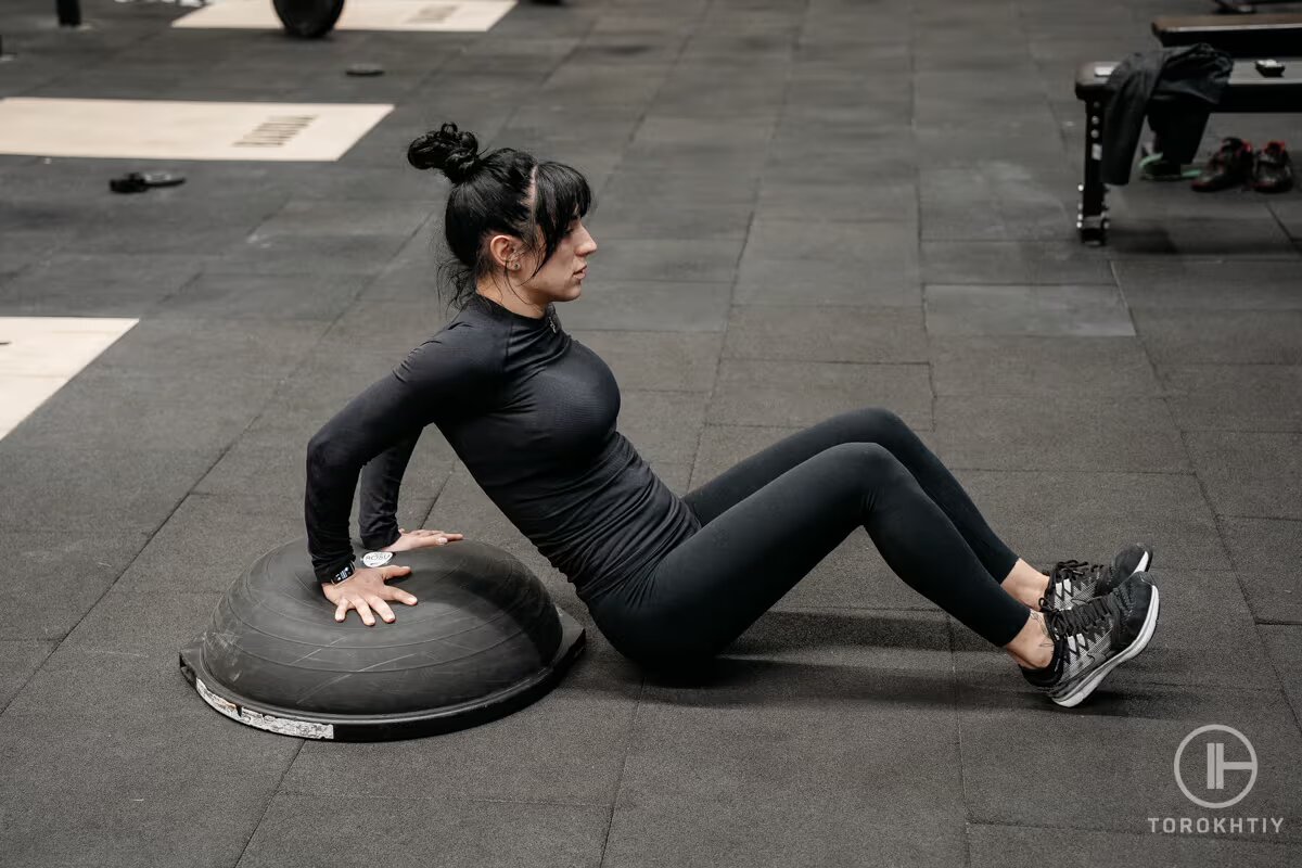 athlete woman doing exercise with bosy ball