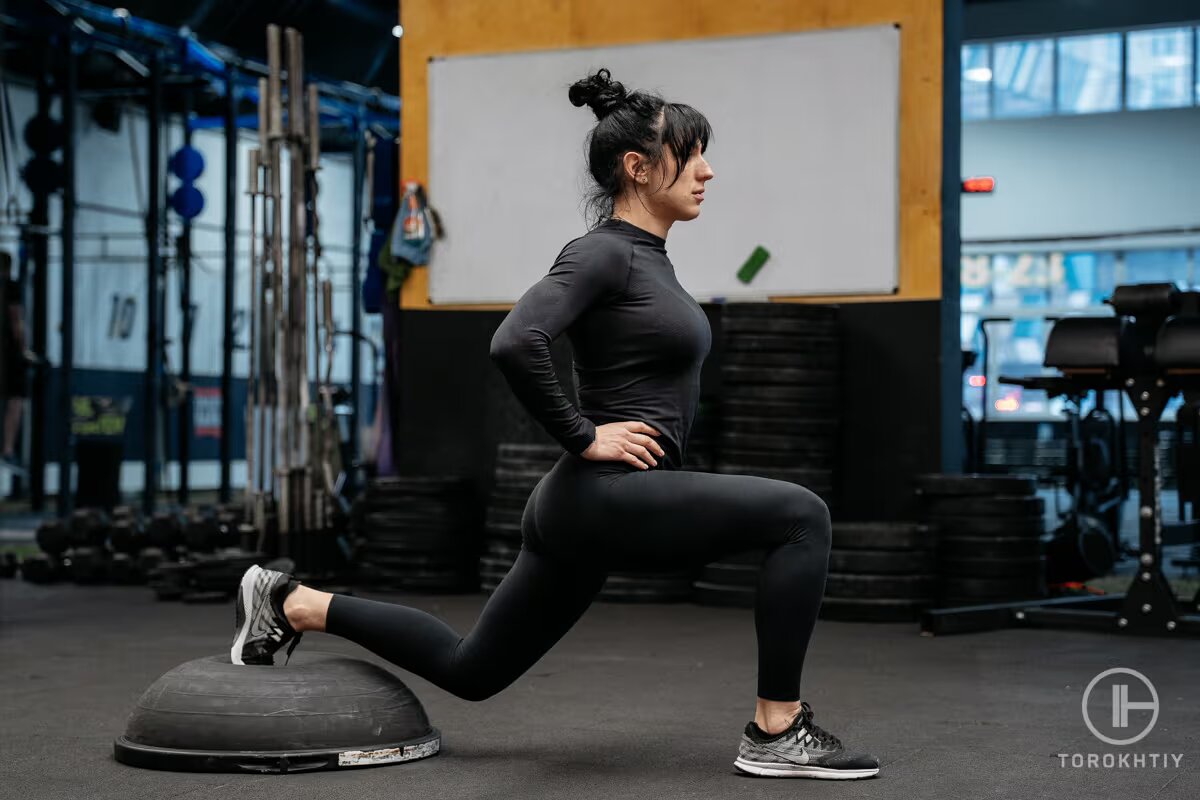 athlete woman works out with bosu ball