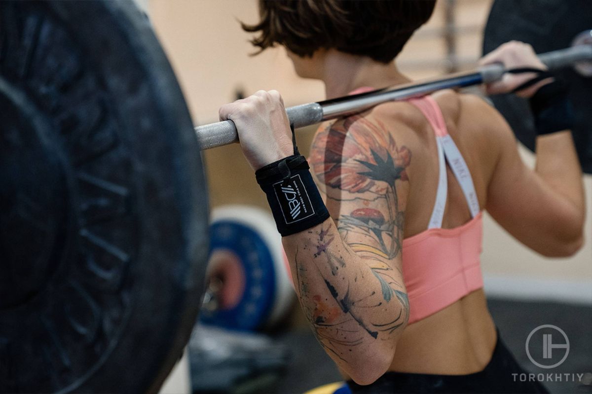 female athlete training with barbell