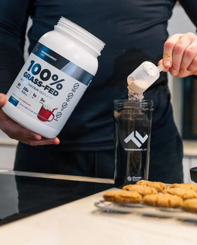 man making transparent labs protein shake and cookies on table