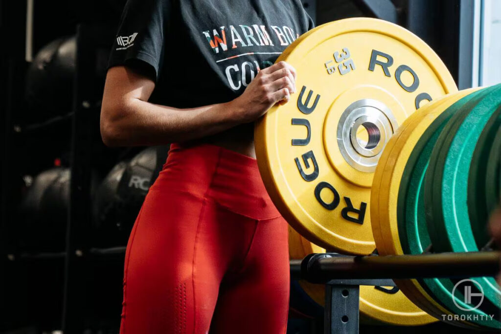 woman athlete holding rogue dumbbell