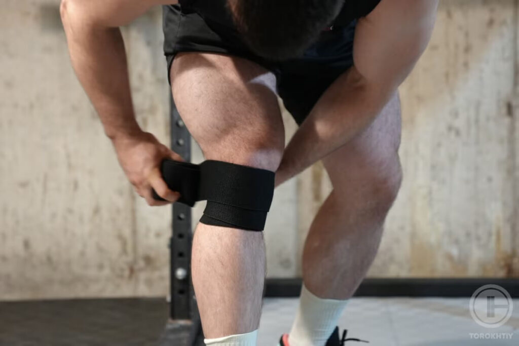 taking knee wrap during workout