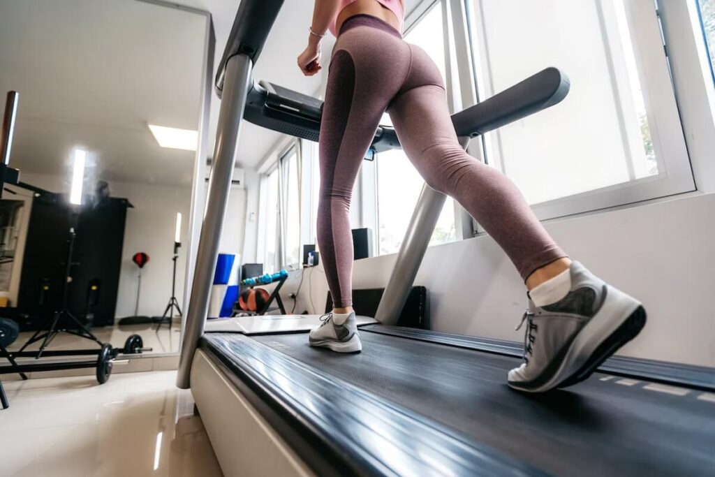 Female treadmill running at home