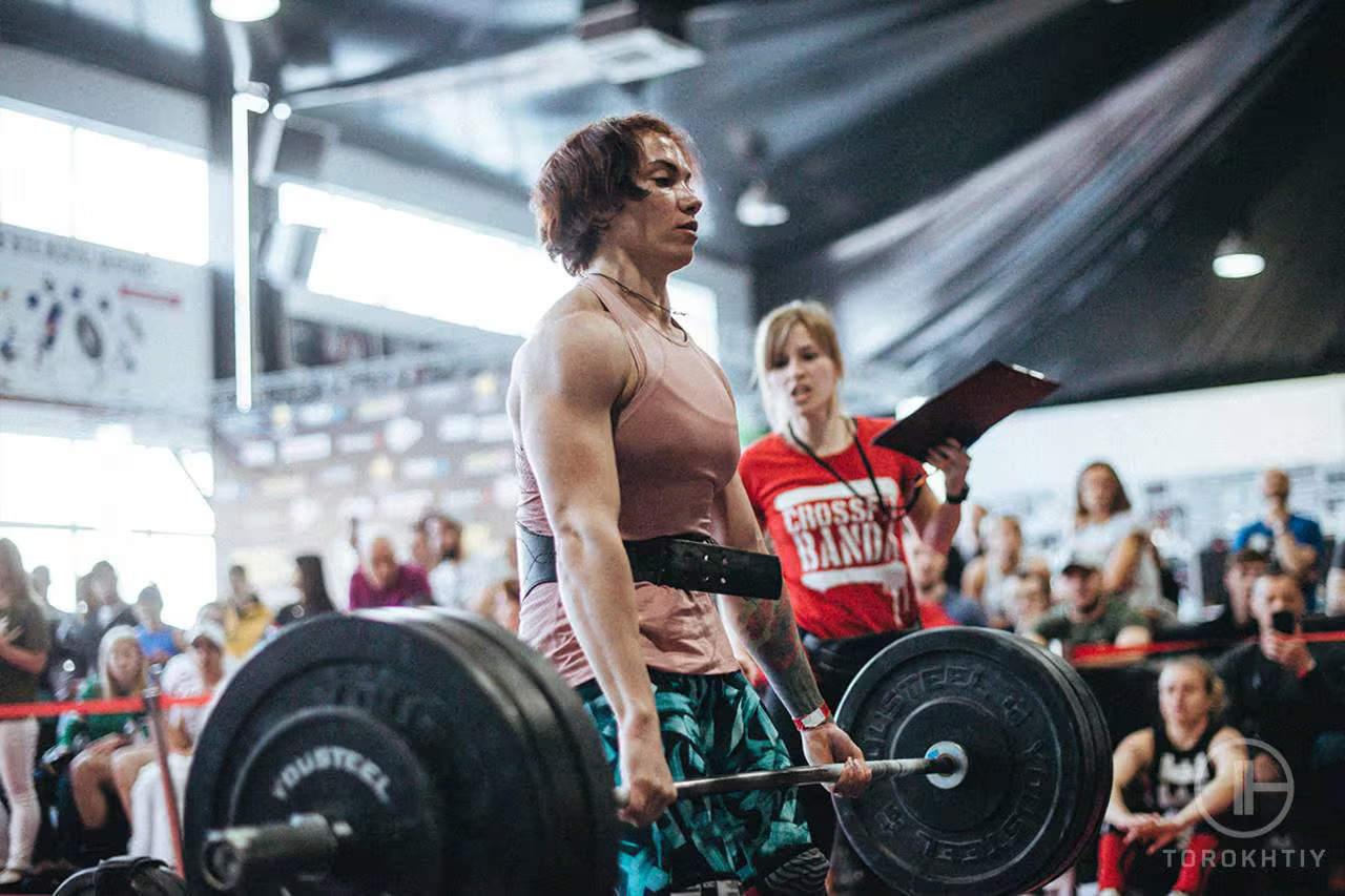 athlete wearing weight belt and lifting barbell
