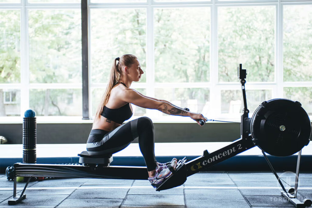 woman works out on rowing machine