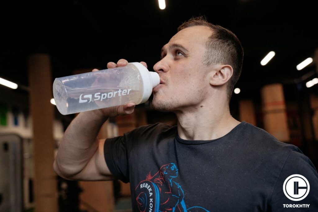 athlete takes supplement shake