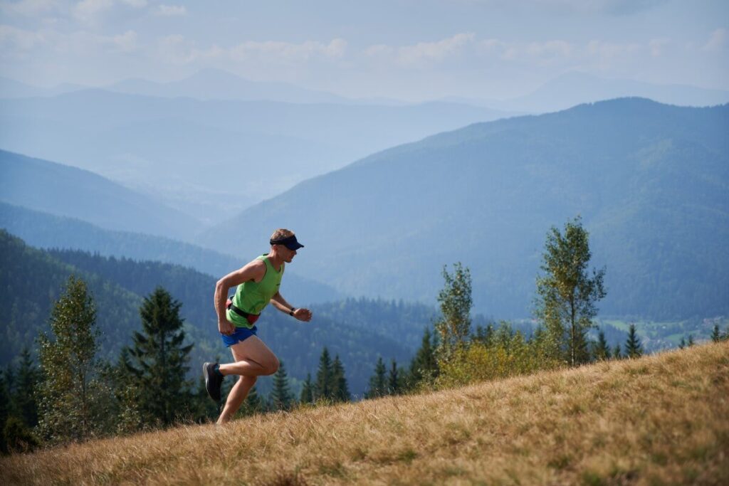 Athletic Man Running Up Hill Mountains