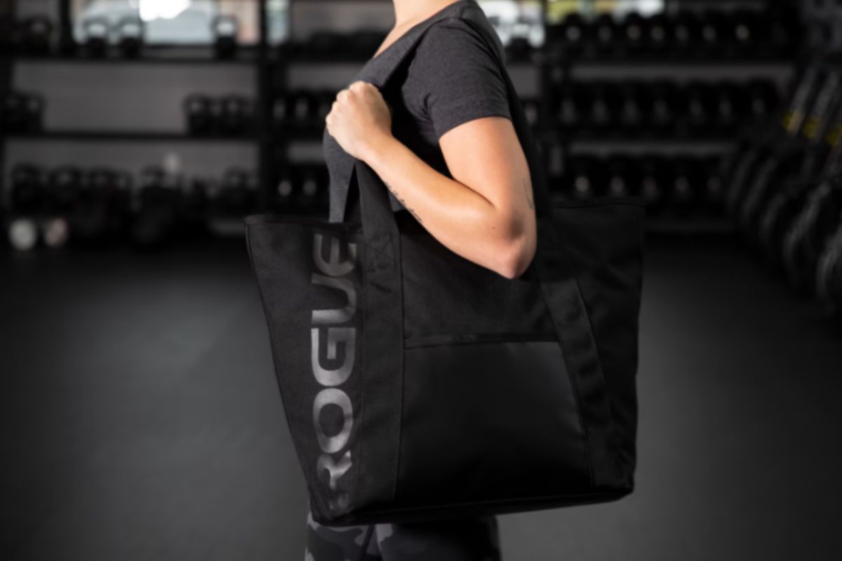 Woman with Rogue Fitness tote bag