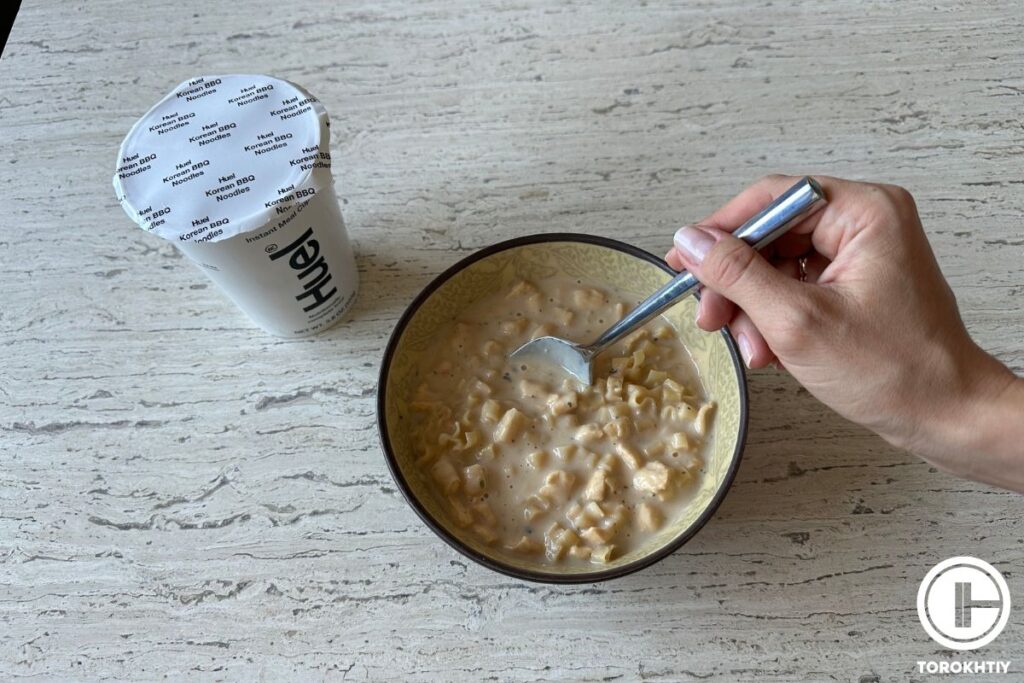 eating huel hot & savory cup