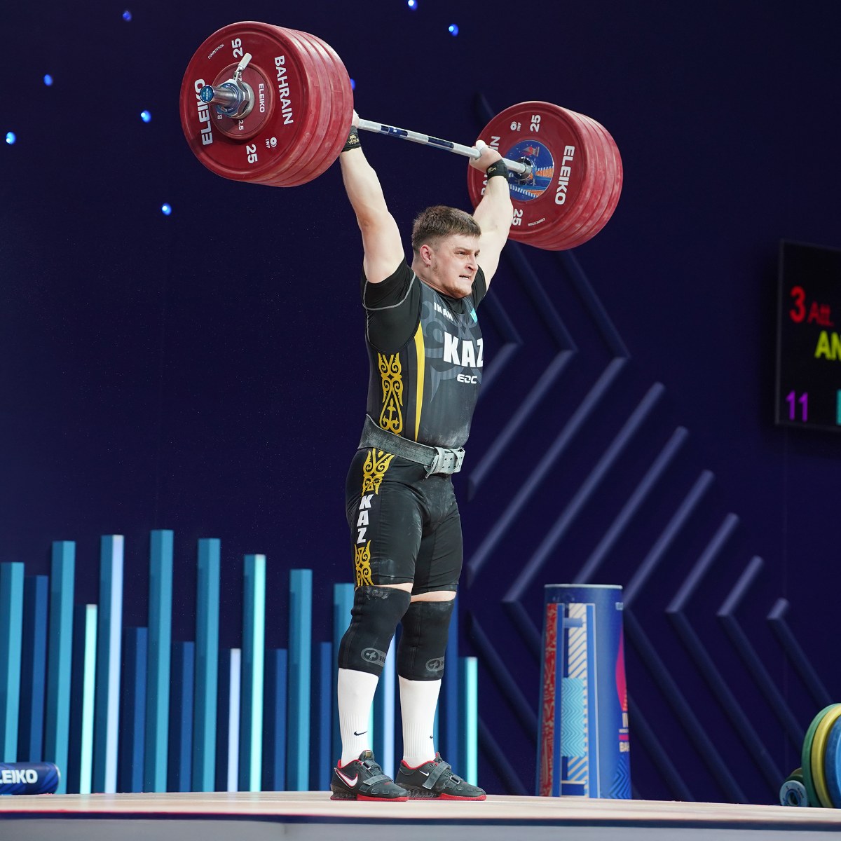 Weightlifter lifting heavy barbell overhead