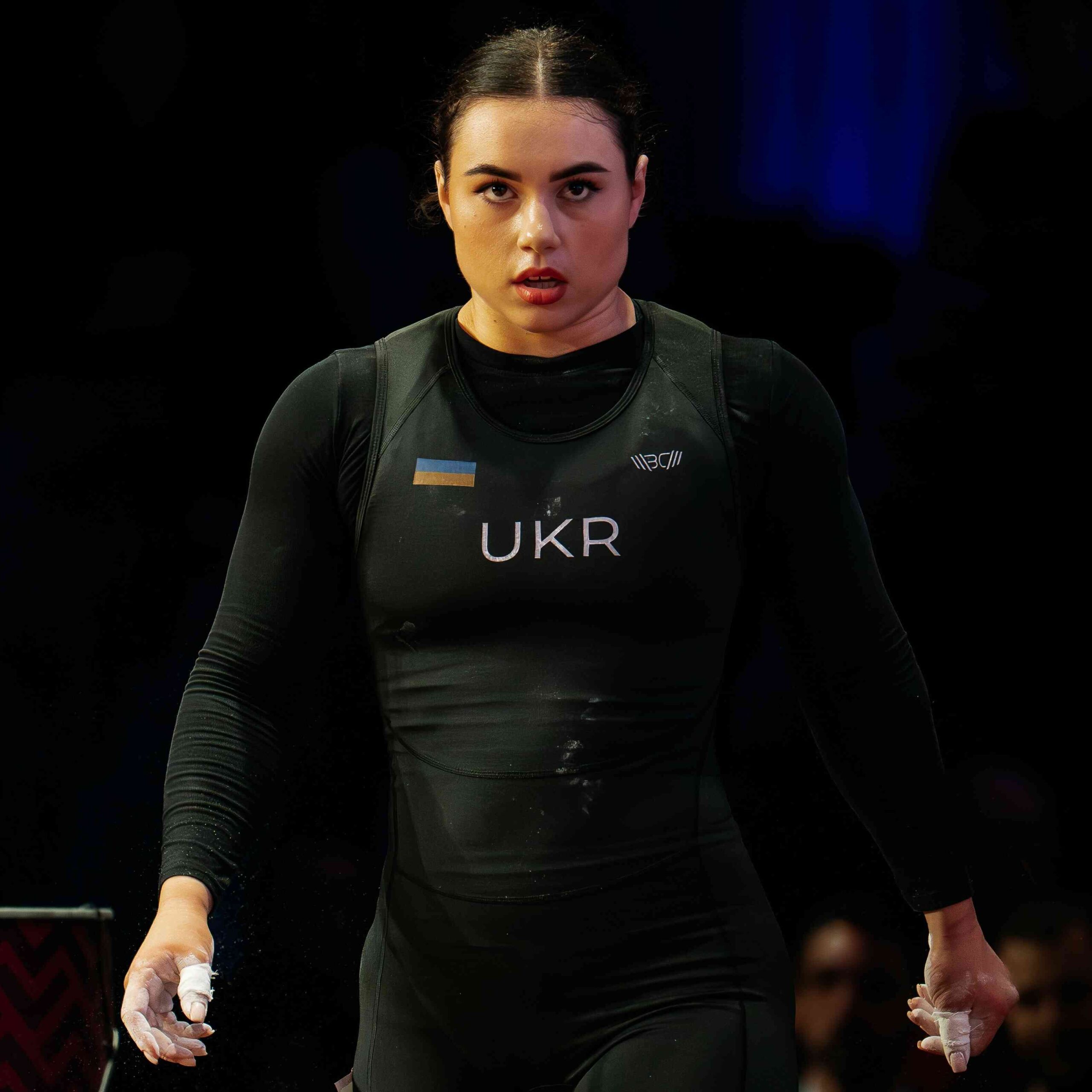 Dombrovska Iryna in competition attire, focused stance (Torokhtiy Weightlifting)